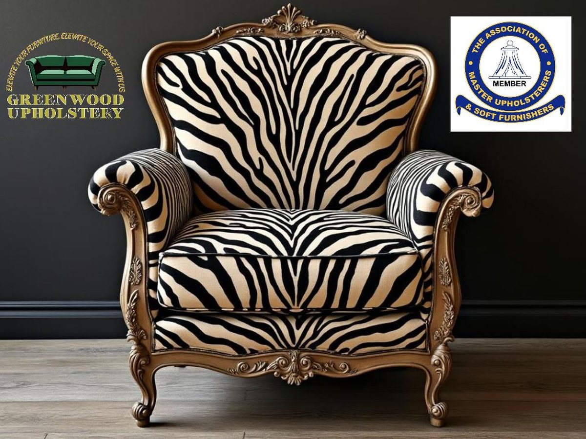 A carved wing chair re-upholstered in zebra-print fabric by Greenwood Upholstery